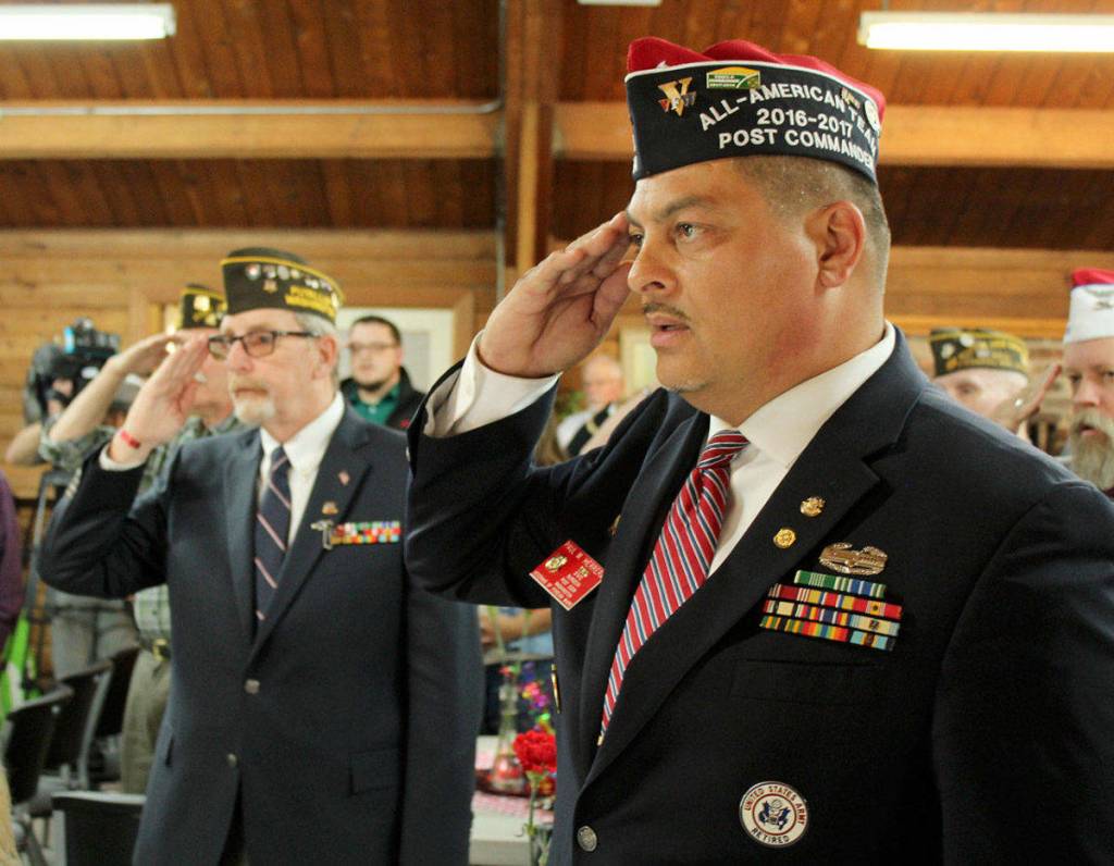 Sergeant Steve Woodward, left, and Commander Paul Herrera salute the flag during the ceremony. Olivia Sullivan/Federal Way Mirror