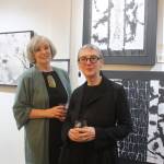 Karen Dedrickson and Chris Baumgartner pose in front of their artwork at Clarke and Clarke Art and Artifacts on Mercer Island. Katie Metzger/staff photo