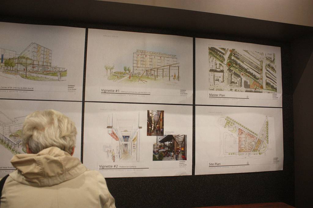 A woman reviews Rêve Developments plans for the Tullys site on Mercer Island. Katie Metzger/staff photo