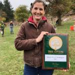 Alaine Sommargren, the citys natural resources manager, shows off a plaque designating Mercer Island as a Tree City USA. Photo courtesy of Julie Underwood
