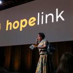 Dr. Tererai Trent borrows props from the audience - a pair of glasses and a handbag - as part of her speech on the power of education at Hopelinks 23rd annual Reaching Out luncheon on Oct. 15. Katie Metzger/staff photo