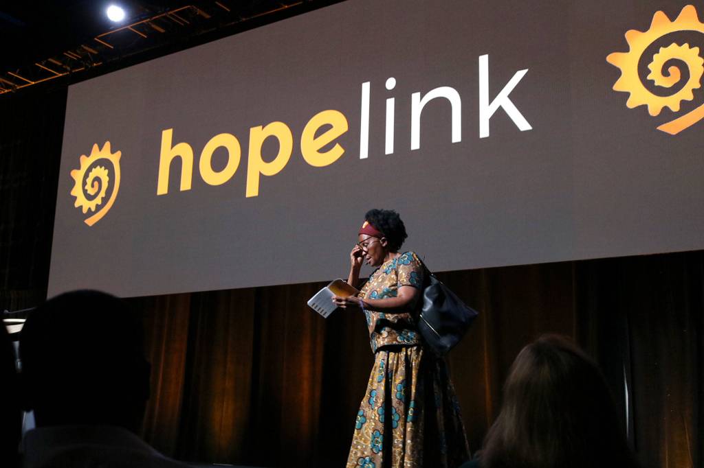 Dr. Tererai Trent borrows props from the audience - a pair of glasses and a handbag - as part of her speech on the power of education at Hopelinks 23rd annual Reaching Out luncheon on Oct. 15. Katie Metzger/staff photo