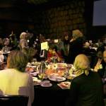 Hopelink luncheon attendees at the Muslim Association of Puget Sound (MAPS) table chat at the end of the event. Katie Metzger/staff photo