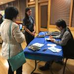 Marknisha Hervol, an eighth grader at Environmental & Adventure School in Kirkland, gets her book signed by Fredi Lajvardi during his appearance at the Peter Kirk Community Center. Samantha Pak/staff photo
