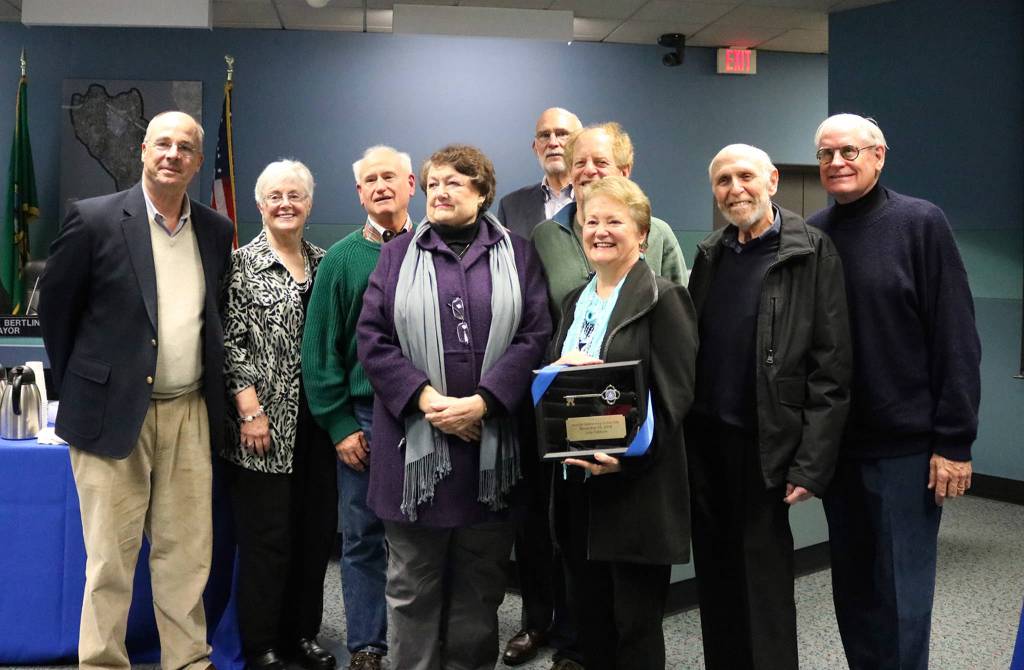 Judy Clibborn holds her key to the city while smiling with colleagues who served with her on the Mercer Island City Council, including Linda Jackman, Susan Blake, Dan Grausz, Elliot Newman and Fred Jarrett. Katie Metzger/staff photo