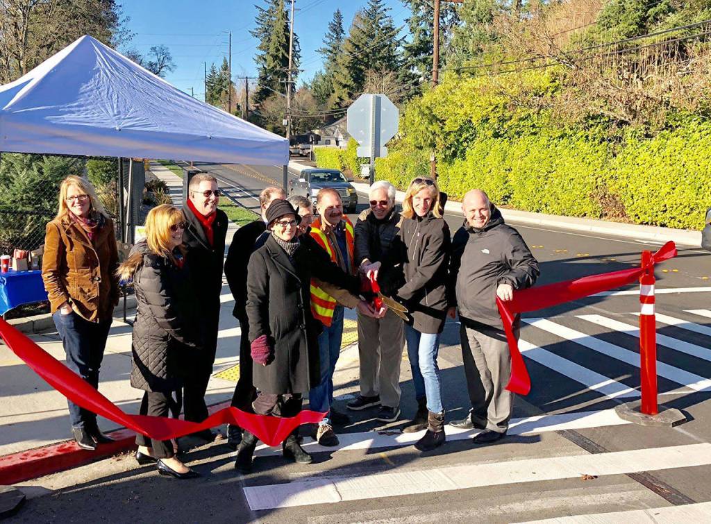 Mercer Island City Councilmember Wendy Weiker, Mercer Island School District Superintendent Donna Colosky, School Board members Brian Giannini Upton and Tracy Drinkwater, Mayor Debbie Bertlin and others help cut the ribbon for a new Safe Route to School project near Northwood Elementary. Photo via Facebook