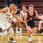 Mercer Island senior guard Will Lee, left, pressures Juanita junior Cooper Mcleod during the first half of play. Lee finished with 14 points against the Rebels. Photo courtesy of Rick Edelman/Rick Edelman Photography