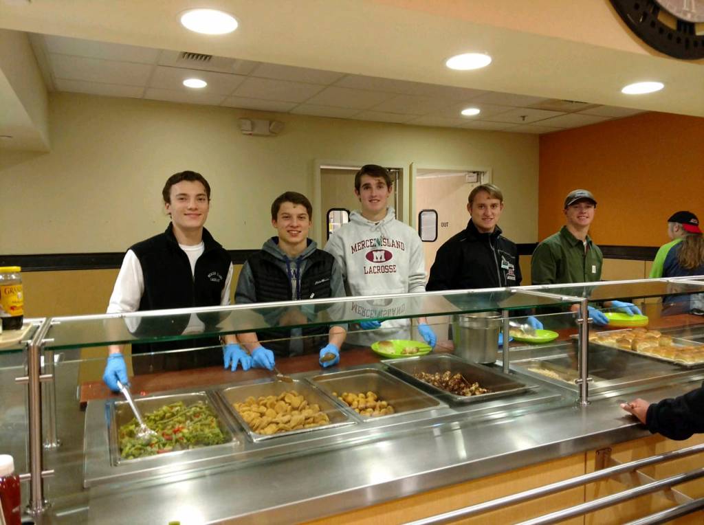 Members of the Mercer Island Lacrosse Club spent the evening of Dec. 12 volunteering at the Union Gospel Missions Hope Place in Seattle. The players prepared and served dinner to more than 100 guests who enjoyed a meal of chicken satay, rice, peanut sauce, mixed vegetables, fruit skewers and a brownie sundae bar. The Union Gospel Missions Hope Place is a shelter that serves women and children. Mercer Island boys lacrosse players Peter Davis, Paul Murdoch, Hunter Johnson, Rurger Marks and Stu Vassau are pictured in the above photo. Photo courtesy of Maryellen Johnson