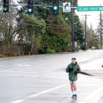 Mercer Island resident Steven Schickler jogs down a crosswalk between SE 40th ST and Island Crest Way Thursday Morning. Drew Stuart/staff photo.