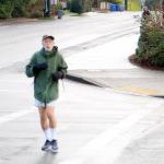 Mercer Island resident Steven Schickler jogs down a crosswalk between SE 40th ST and Island Crest Way Thursday Morning. Drew Stuart/staff photo.
