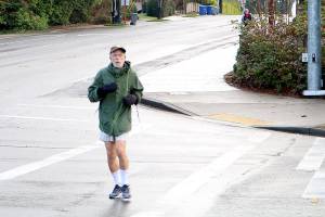Mercer Island resident Steven Schickler jogs down a crosswalk between SE 40th ST and Island Crest Way Thursday Morning. Drew Stuart/staff photo.