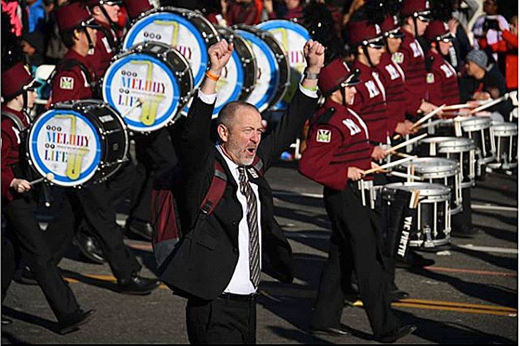 MIHS marching band teacher, Parker Bixby, cheers as the band marches in the Tournament of Roses parade. Photo courtesy of Unofficial_MIHSBand Instagram page.