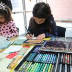 Sofia Gusu, 6, and Iana Gusu, 8, from Redmond, draw butterflies with water soluble colored pencils at a Northwest Artists in Action pop-up at the Mercer Island Community and Event Center on Jan. 26. Katie Metzger/staff photo