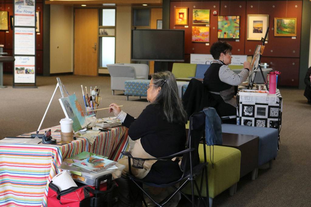 Vasana Monti and Terri Davis of Northwest Artists in Action paint in the lobby of the Mercer Island Community and Event Center. Katie Metzger/staff photo