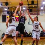The Lake Washington Kangaroos girls basketball team captured a 64-53 win against the Mercer Island Islanders on senior night on Jan. 30 at Mercer Island High School. The Islanders dropped to 1-18 overall with the loss. Mercer Island seniors Sarah Gest, right, and Rio Beutelspacher, left, try to stop Lake Washington guard Rosa Smith, center, as she drives to the hoop. Photo courtesy of Don Borin/Stop Action Photography