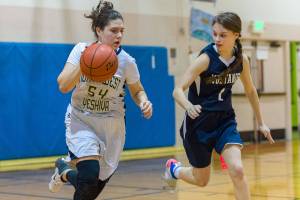 Northwest Yeshiva senior Zohar Hemmet, left, dribbles the ball down the court in the final game of her high school career against Rainier Christian on Jan. 30. Northwest Yeshiva finished the 2018-19 season with an overall record of 4-16. Photo courtesy of Patrick Krohn/Patrick Krohn Photography