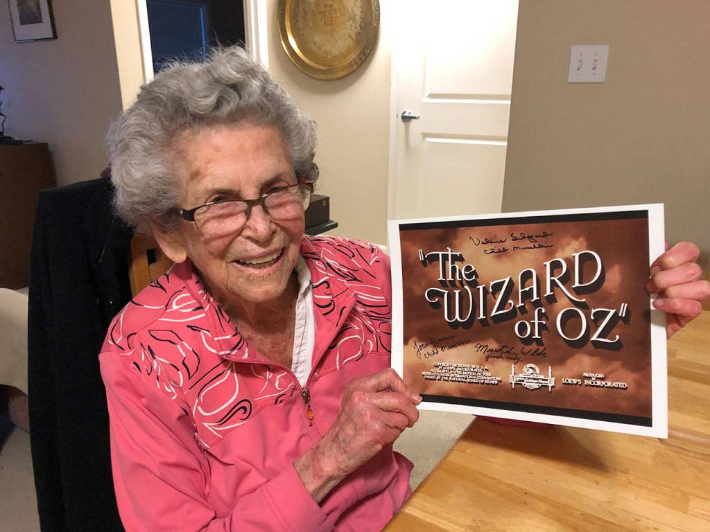 Mercer Island resident Meredythe Glass poses with memorabilia from The Wizard of Oz. Glass was an extra in the film, and will be the guest of honor at a party at her retirement community celebrating Hollywood on Feb. 22. Photo courtesy of Greg Asimakoupoulos