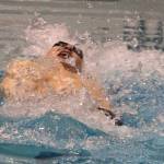 Mercer Islands James Richardson plows through the 100 backstroke on his way to victory. Andy Nystrom / staff photo