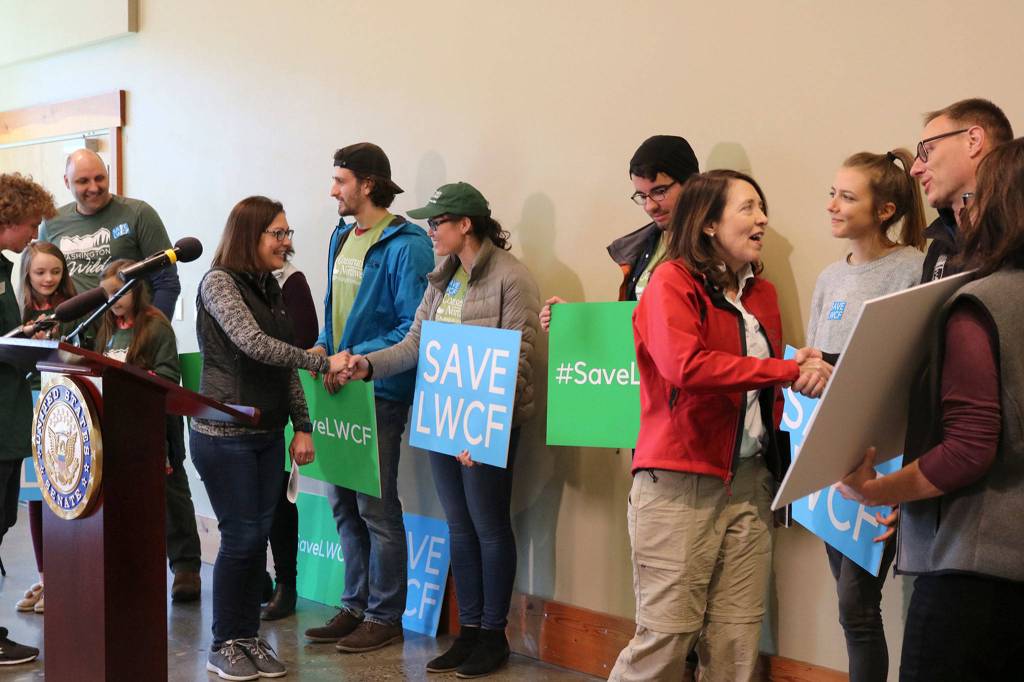 Sen. Maria Cantwell and Rep. Suzan DelBene shake hands with outdoor enthusiasts and conservationists before a rally to save the Land and Water Conservation Fund in Seattle on Feb. 21. Katie Metzger/staff photo