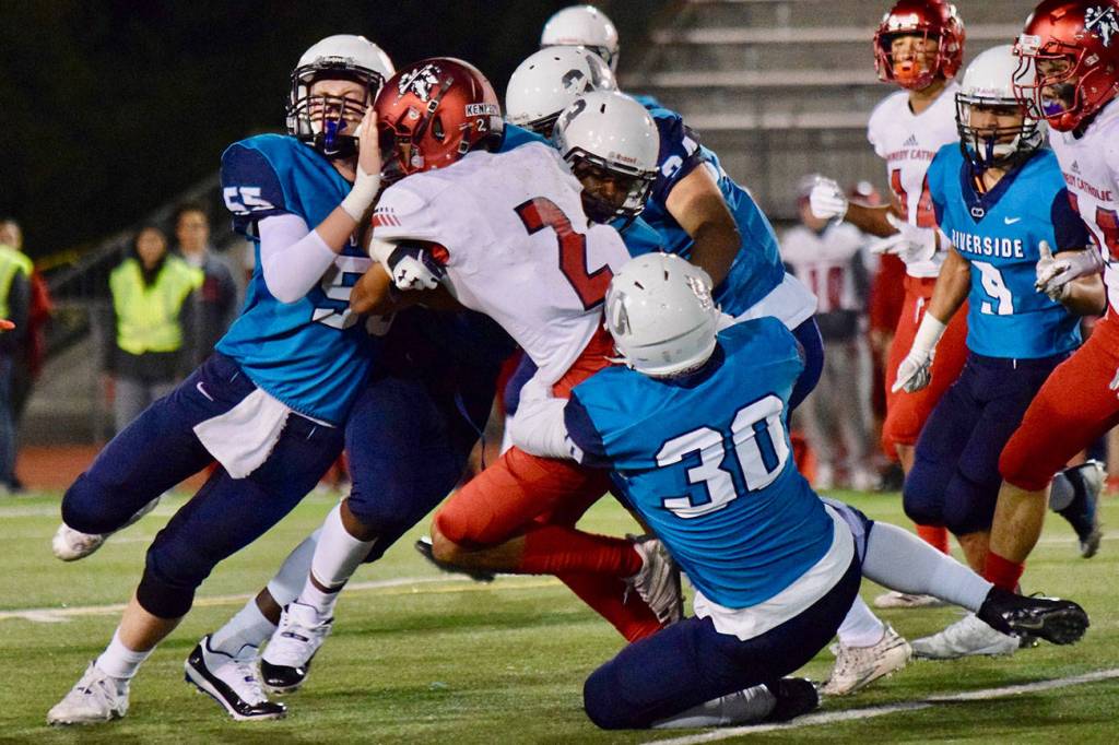 Auburn Riverside defenders bring down Kennedy Catholics Junior Alexander during North Puget Sound League Mountain Division action in Oct. 2018 at Auburn Memorial Stadium. Photo by Rachel Ciampi/Auburn Reporter