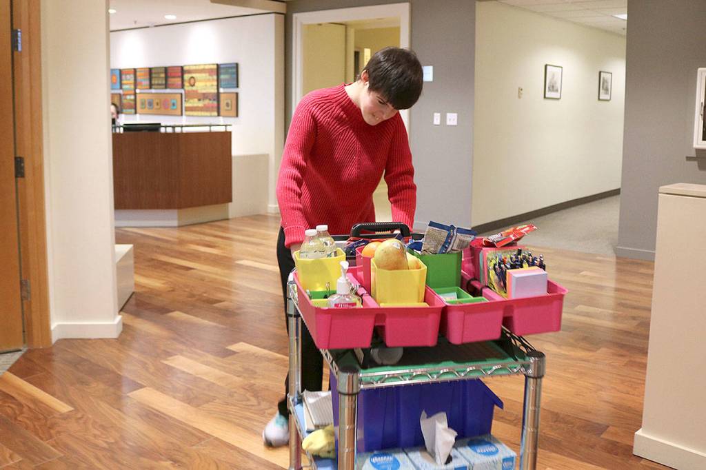 Stephanie Quiroz/staff photo                                 Paige Bisbee, of Bellevue is a paid employee at Davis Wright Tremaine in Bellevue. As part of the law firms inclusive program, Bisbee distributes snacks and office supplies to her co-workers.