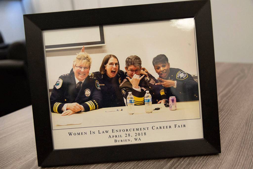 Redmond Police Chief Kristi Wilson, Bothell Police Chief Carol Cummings, King County Sheriff Mitzi Johanknecht and Seattle Police Chief Carmen Best smile in a photo on Johanknechts desk. They are some of Seattles leading women in law enforcement. Ashley Hiruko/staff photo