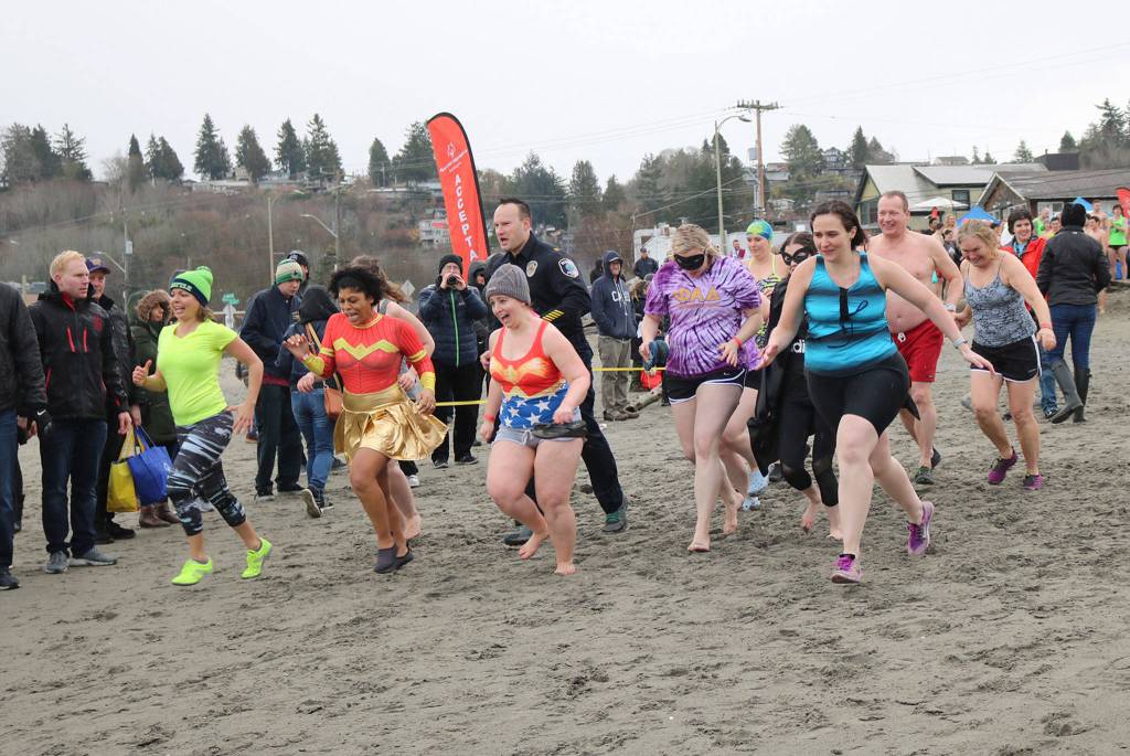 The Redmond Police Department team, wearing swimsuits and costumes, gets ready to take the polar plunge into Puget Sound. Katie Metzger/staff photo