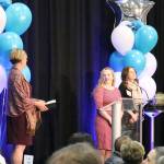 Jody Kris gives Traci Granbois and and Laura Oberto, co-presidents of the Mercer Island Preschool Association, the 2019 philanthropy award at the MIYFS Foundation Annual Breakfast. Katie Metzger/staff photo