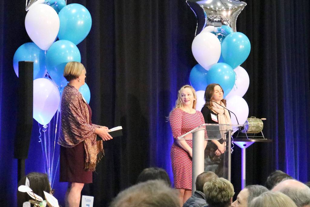 Jody Kris gives Traci Granbois and and Laura Oberto, co-presidents of the Mercer Island Preschool Association, the 2019 philanthropy award at the MIYFS Foundation Annual Breakfast. Katie Metzger/staff photo