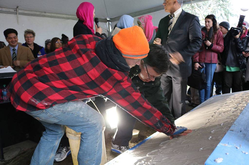 Redmond Mayor John Marchione was among many community members to place their hand prints in the wet cement below the new sign at the Muslim Association of Puget Sound in Redmond after the mosques old sign was vandalized in 2016. File photo