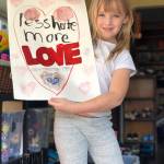 Photo courtesy of Ashley Sternberg                                 8-year-old Lucy Sternberg holds up her sign, created for a community rally on Mercer Island.