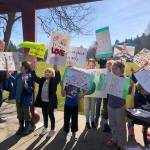 Children hold rally signs. Photo courtesy of Ashley Sternberg