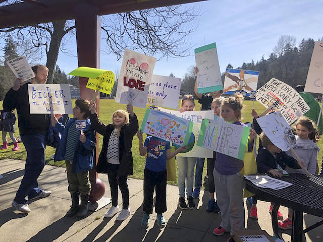 Children hold rally signs. Photo courtesy of Ashley Sternberg