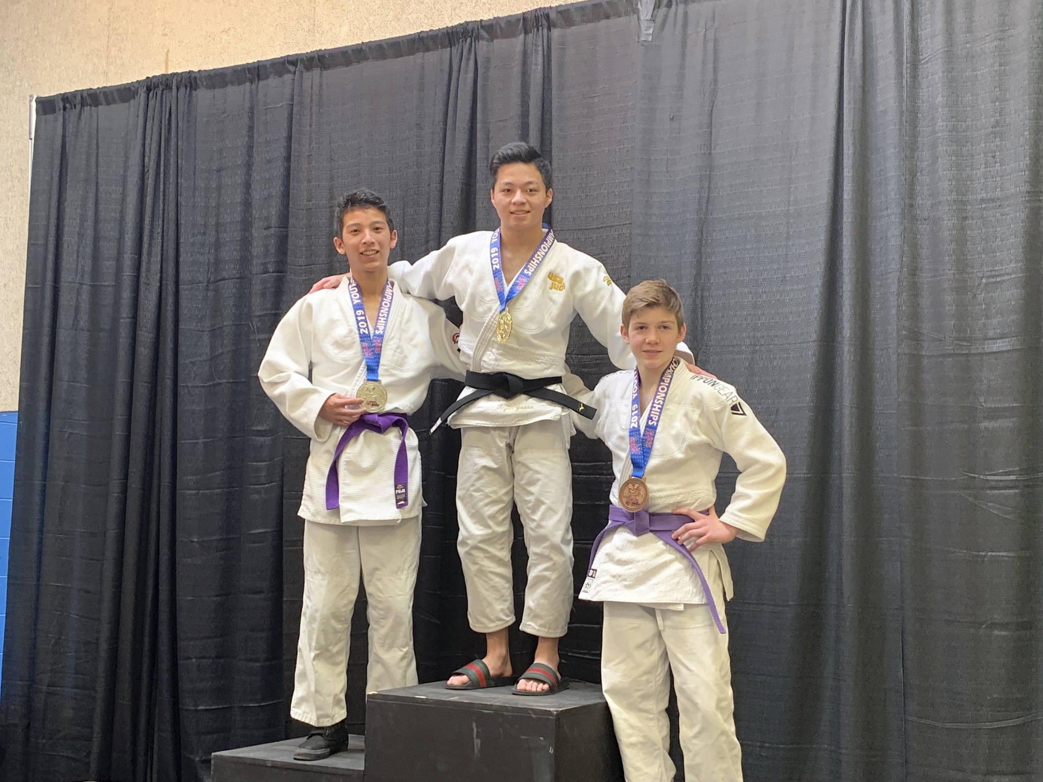Mercer Island High School sophomore Tegan Yuasa, center, stands on the top spot at the podium sporting a gold medal from the USA Judo Youth National Championships on March 10 in Colorado Springs, Colorado. Photo courtesy of Mark Yuasa