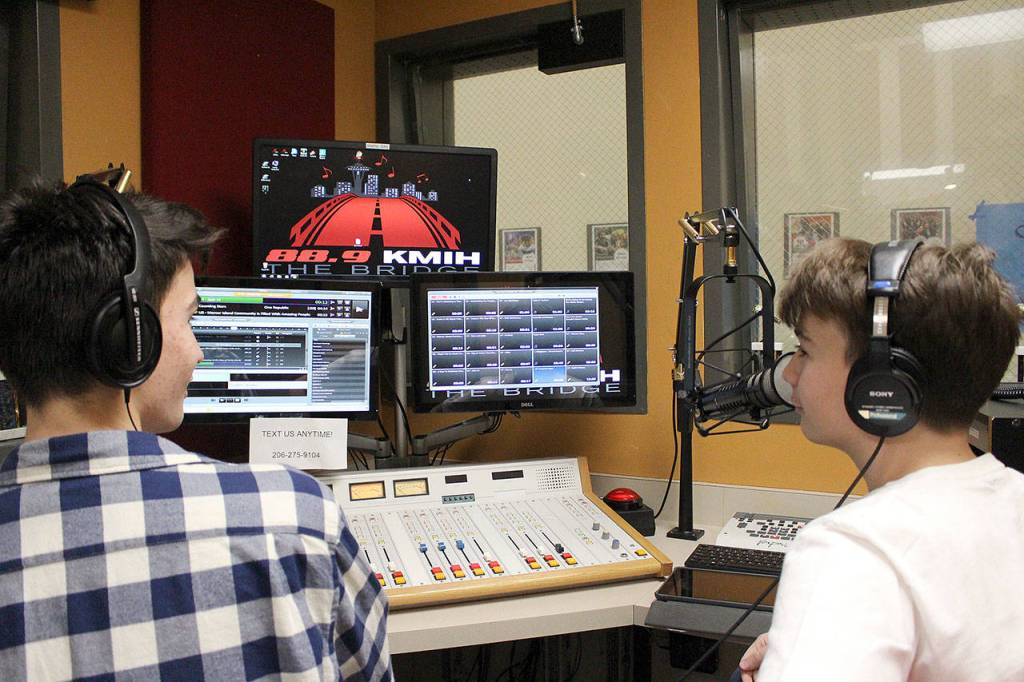Senior Luka Marceta, left, and freshman Marka Marceta wrap up their segment on KMIH 88.9 The Bridge on The Day of Unity. Madison Miller /staff photo