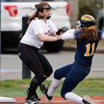 Mercer Island third baseman Caitlyn Barber, left, tags out Bellevue baserunner Rachel Treves, right, during a matchup between rivals on April 3 at the South Mercer playfields. Bellevue defeated Mercer Island, 35-0. Photo courtesy of Jim Nicholson