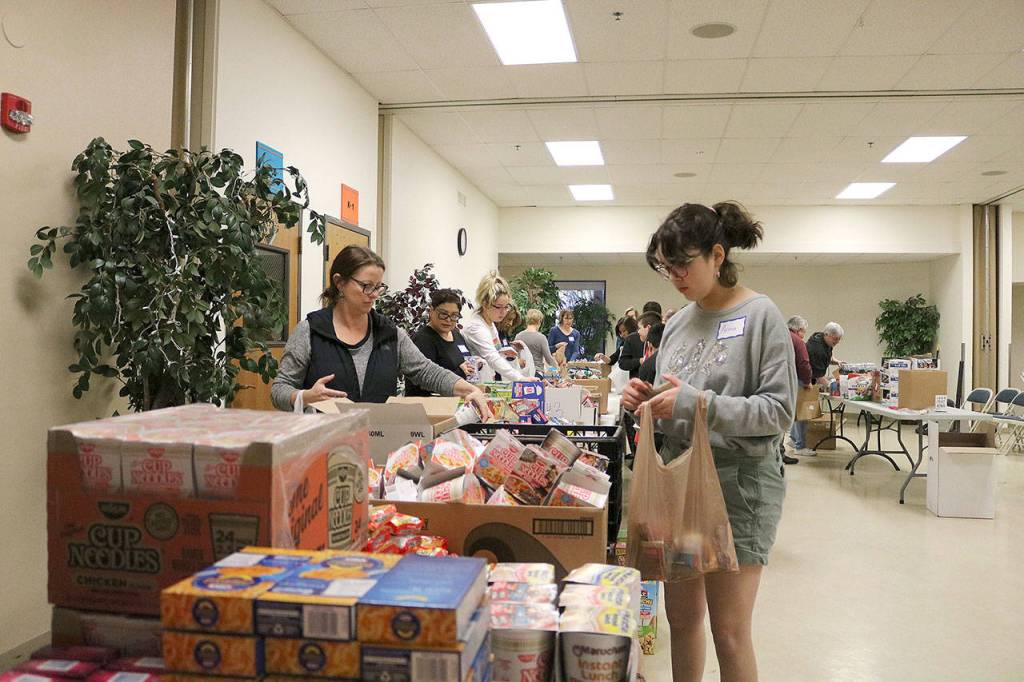 Church members assembled Pantry Packs that were given to the Lake Washington school District for children living in poverty. Stephanie Quiroz/staff photo.