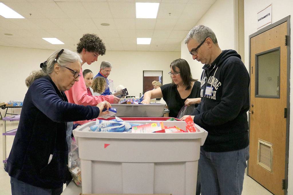 Retail stores in Bellevue, Redmond and Kirkland donated gift cards to purchase items for the hygiene kits and pantry packs. Stephanie Quiroz/staff photo.