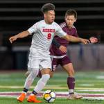 Juanita Rebels midfielder Victor Ramos Agular, left, controls the ball while being guarded by Mercer Island midfielder Joshua Chang, right. Photo courtesy of Patrick Krohn/Patrick Krohn Photography