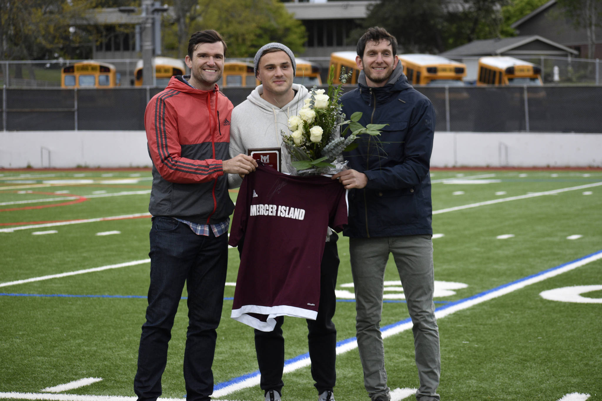Former Mercer Island Islanders boys soccer head coach Colin Rigby, left, Jordan Morris, center, and Islanders boys soccer head coach Forrest Marowitz pose for a quick photo on April 23 at Islander Stadium. Morris was inducted into the Mercer Island High School Athletic Hall of Fame. Photo courtesy of Kim Otte