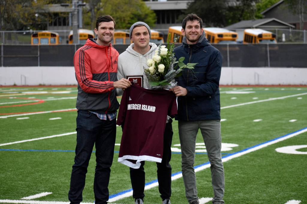Former Mercer Island Islanders boys soccer head coach Colin Rigby, left, Jordan Morris, center, and Islanders boys soccer head coach Forrest Marowitz pose for a quick photo on April 23 at Islander Stadium. Morris was inducted into the Mercer Island High School Athletic Hall of Fame. Photo courtesy of Kim Otte