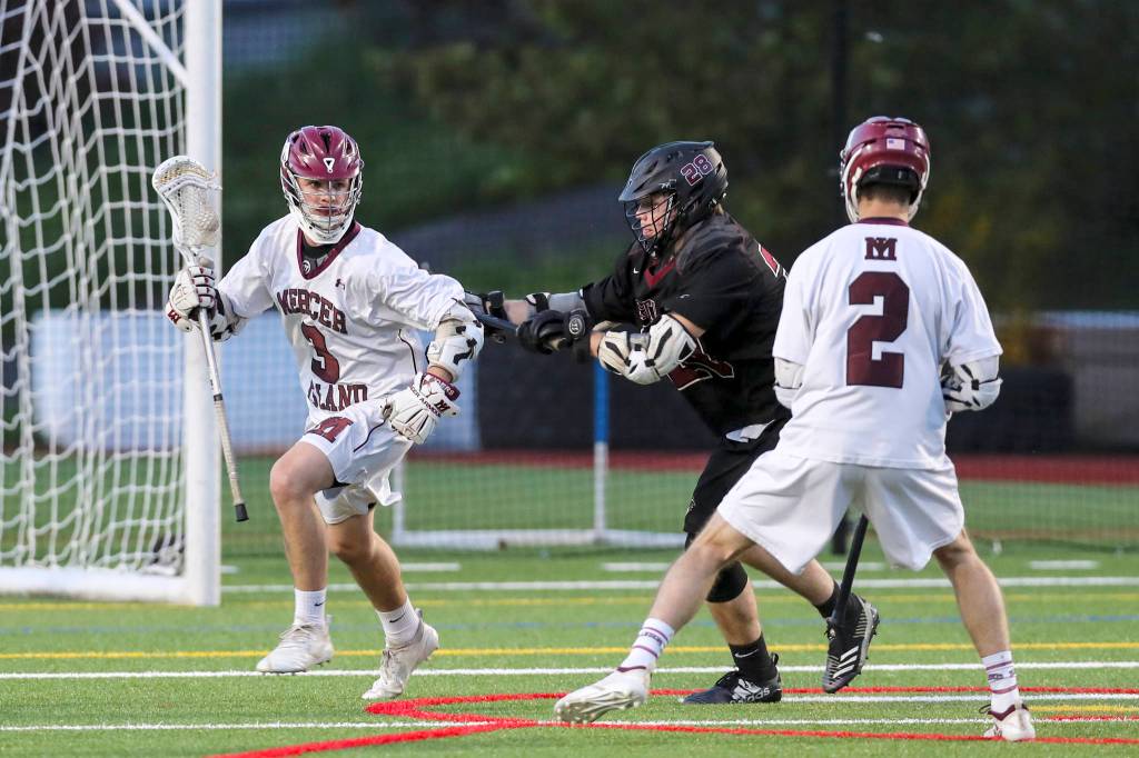 Mercer Island senior Scotty Rowe, left, scored a game-high four goals against the Eastlake Wolves. Mercer Island clinched the No. 1 seed to the playoffs from the KingCo Conference courtesy of its 17-4 victory against Eastlake on May 1. Photo courtesy of Rick Edelman/Rick Edelman Photography