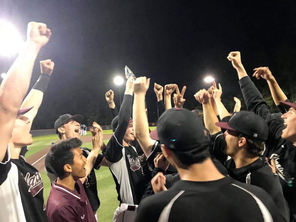 Mercer Island Islanders celebrate after being presented the KingCo 3A baseball tournament championship trophy just minutes following the final out against the Interlake Saints on May 6 at Bannerwood Park in Bellevue. Shaun Scott/staff photo