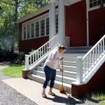 Liz Carson, Sunnybeam Schools director, sweeps away gravel from the schools stairs. Madison Miller / staff photo
