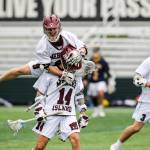 Mercer Island player Glen Mahony (No. 9) leaps on the back of Will Wheeler (No. 14) during the 3A state championship game against the Bellevue Wolverines. Mercer Island defeated Bellevue 14-6 on May 25 at the Starfire Sports Complex in Tukwila. Photo courtesy of Rick Edelman/Rick Edelman Photography