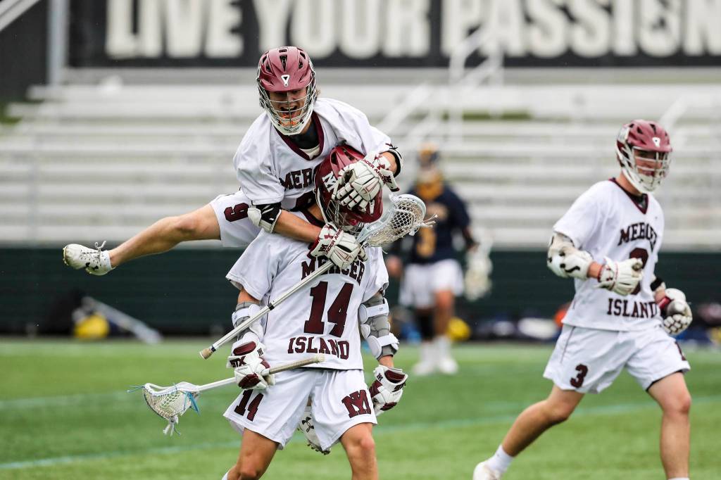 Mercer Island player Glen Mahony (No. 9) leaps on the back of Will Wheeler (No. 14) during the 3A state championship game against the Bellevue Wolverines. Mercer Island defeated Bellevue 14-6 on May 25 at the Starfire Sports Complex in Tukwila. Photo courtesy of Rick Edelman/Rick Edelman Photography