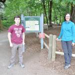 Eagle Scout Elliott Hendrickson and Kim Frappier from the Citys Parks and Recreation Department with the new Pioneer Park fence.