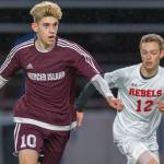 Mercer Island senior Matthew Capone, left, dribbles the ball up field while being guarded by Juanita sophomore Andrew Taylor in a game on April 11. Capone earned first-team all-3A KingCo honors as a midfielder during the 2019 season. Photo courtesy of Patrick Krohn/Patrick Krohn Photography