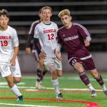Mercer Island Islanders midfielder Matt Capone (right), passes the ball to a teammate in a contest against the Juanita Rebels during the 2019 season. Capone will play soccer at Northwest Nazarene University this fall. Photo courtesy of Patrick Krohn/Patrick Krohn Photography