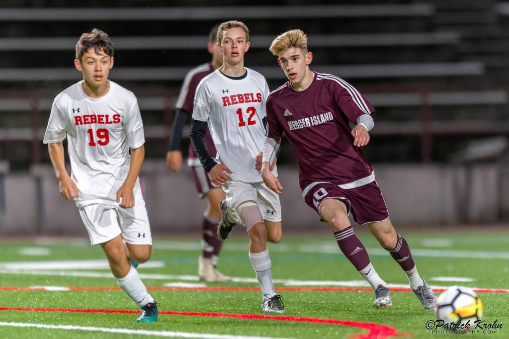 Mercer Island Islanders midfielder Matt Capone (right), passes the ball to a teammate in a contest against the Juanita Rebels during the 2019 season. Capone will play soccer at Northwest Nazarene University this fall. Photo courtesy of Patrick Krohn/Patrick Krohn Photography